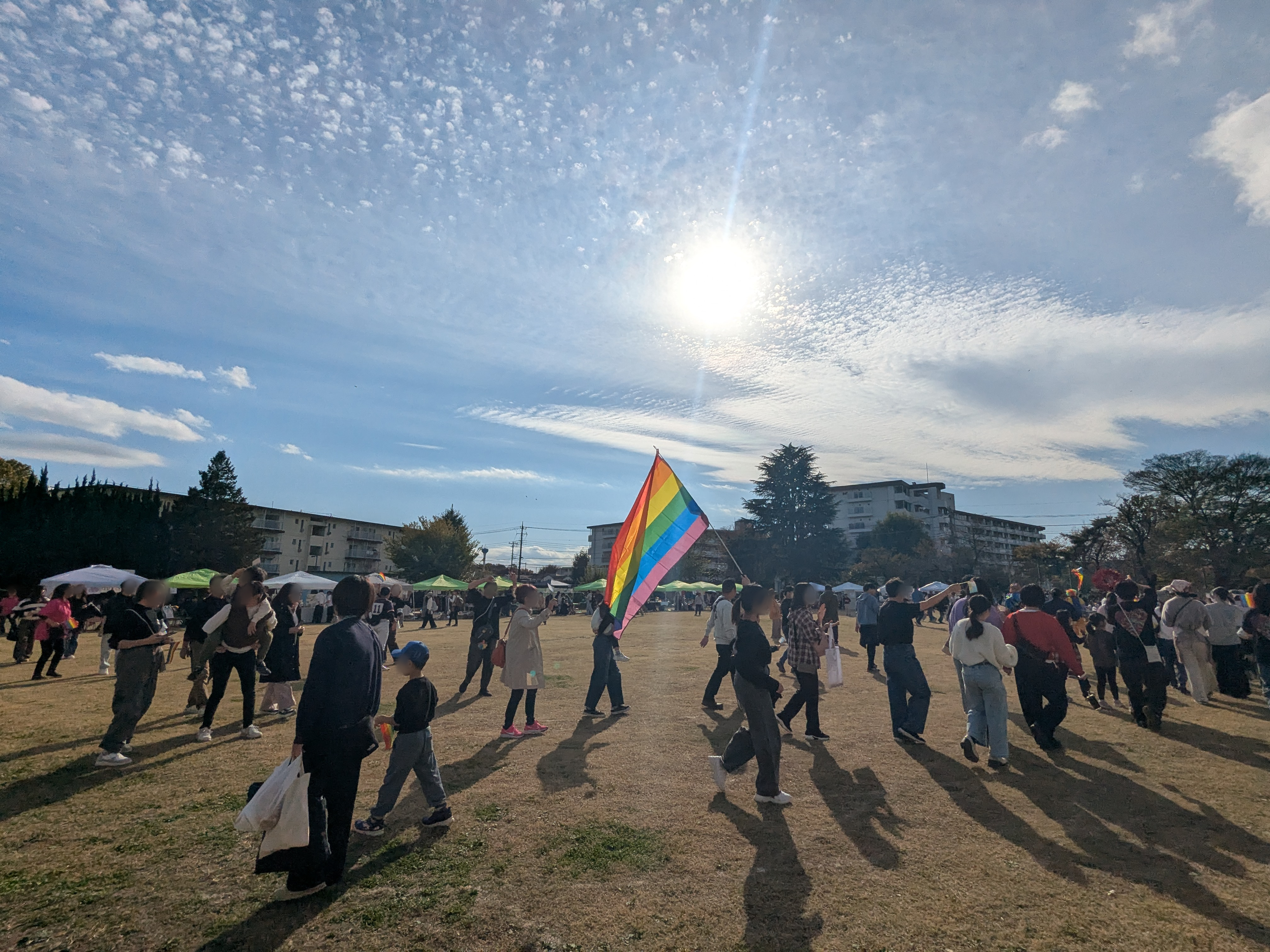 パレードの様子。参加者がレインボーフラッグを掲げながら行進している